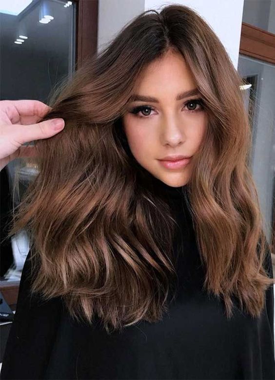 long and volumetric chestnut hair with waves is a beautiful and catchy idea to rock right now
