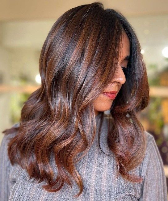long dark hair with chestnut balayage and waves is a stylish and catchy idea for a bold and chic look