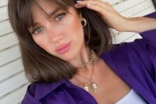 medium length brunette hair with wispy bangs looks chic, thick and beautiful and the bangs accent the eyes