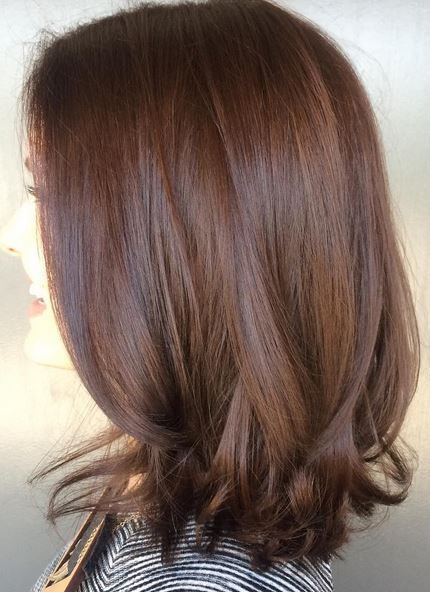 Medium length chestnut brown hair with curled ends and layers and volume is a beautiful solution to rock