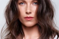 medium-length chestnut hair with waves and volume looks pretty, catchy and stylish