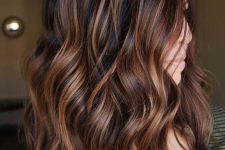 shoulder-length dark hair with chestnut and copper balayage, waves and volume, is a catchy and cool idea