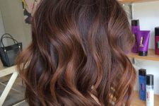 shoulder-length dark hair with chestnut balayage, waves and volume is a stunning and refined idea to rock
