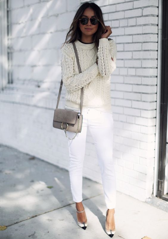 a cable knit ivory sweater, white jeans and heels