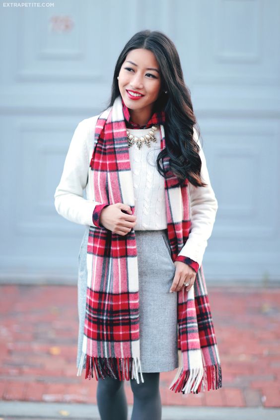 a cable knit sweater, a grey skirt and a plaid sscarf