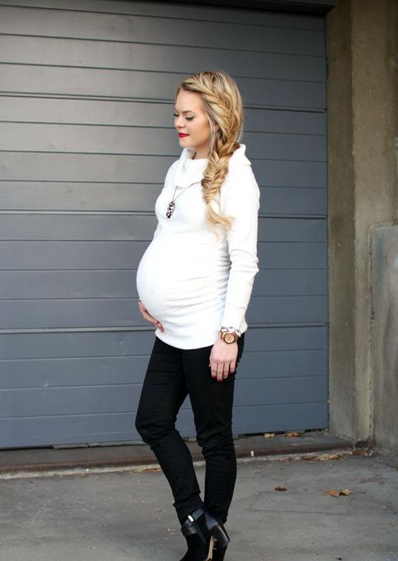 a comfy white turtleneck sweater and black pants for cold weather