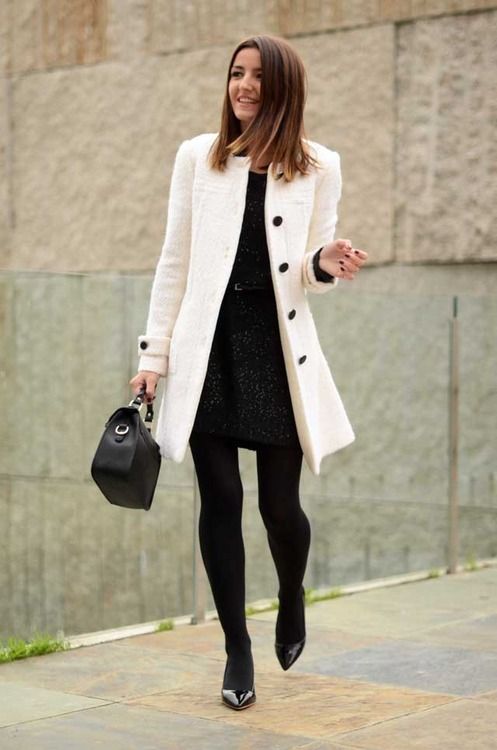 a patterned black mini dress, a white coat and black heels for a timeless look