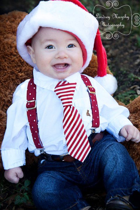jeans, a shirt, a tie, suspenders and a red Santa hat
