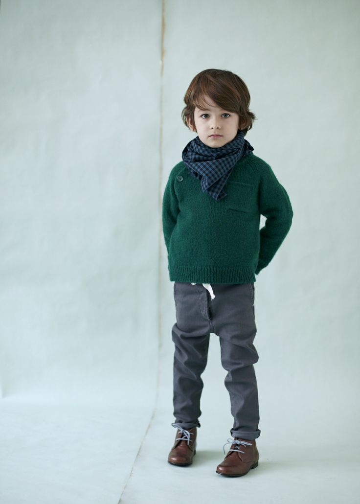 grey pants, an emerald sweater, a plaid scarf and brown boots