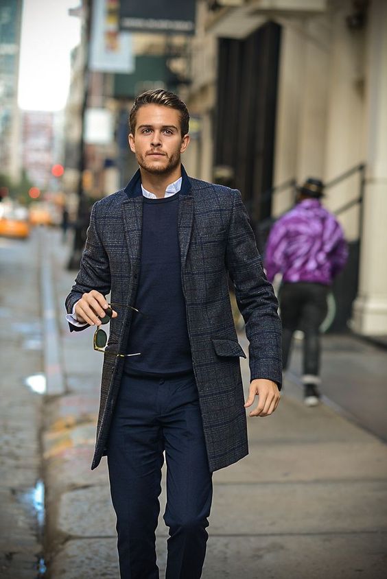 navy pants and a sweater, a plaid tweed coat