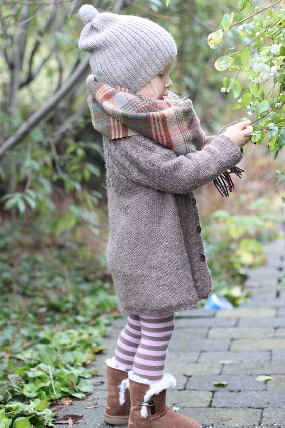 fur boots, striped leggings, a long cardigan and a beanie