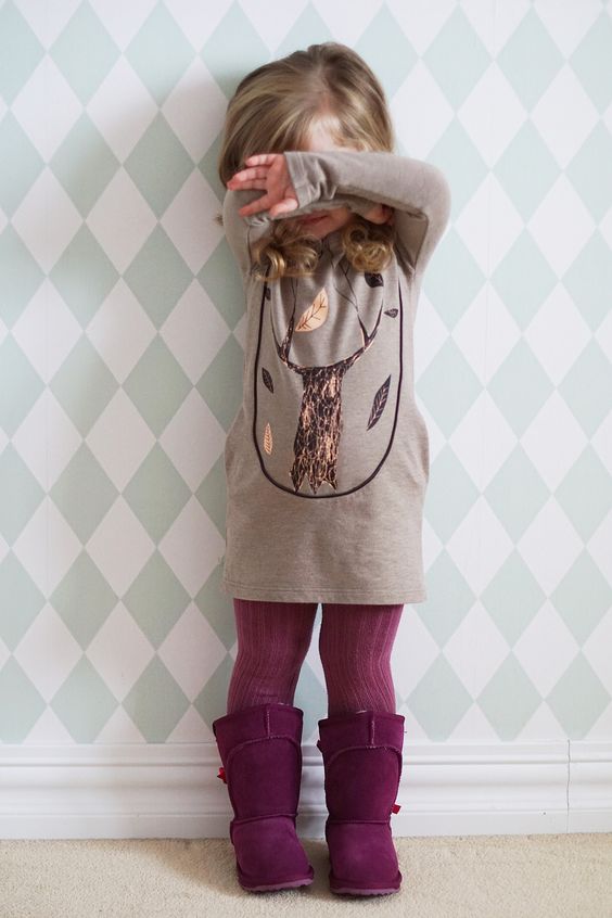 purple tall suede boots and tights of the same shade, a neutral dress with a tree printed