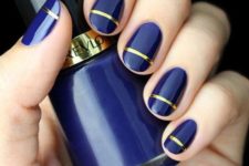 25 royal blue nails with a gold stripe