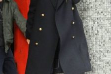 With black double breasted coat and cuffed jeans