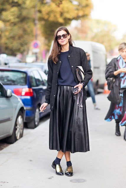 With black leather pleated midi skirt, black jacket and clutch