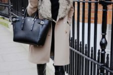 With black shirt, skinnies, over the knee leather boots and big bag
