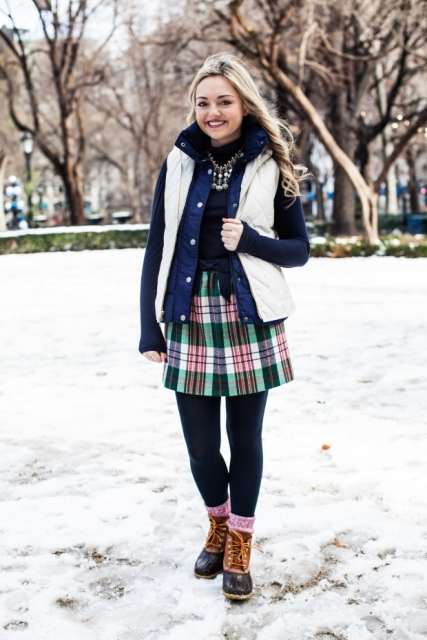 With black shirt, statement necklace, plaid skirt and vest