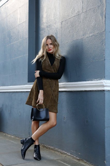 With black turtleneck, suede dress and black small bag