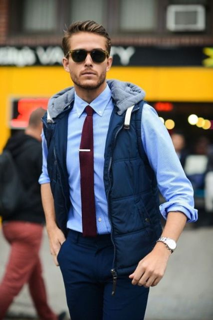 With blue button down shirt, marsala tie and navy blue trousers