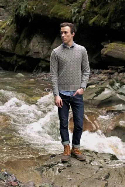 With button down shirt, gray sweater and cuffed jeans