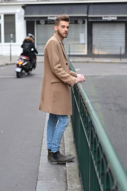 With camel coat and classic jeans