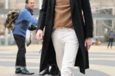 With camel sweater, white straight trousers, black coat and hat