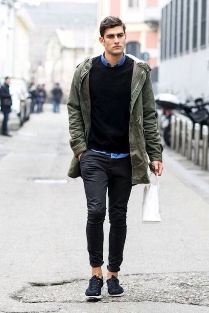 With denim shirt, black sweater and cuffed pants