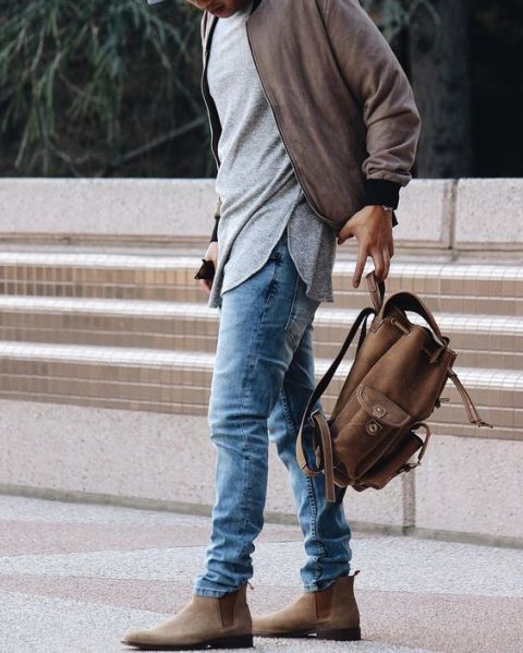 With gray shirt, jacket, jeans and backpack