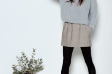 With gray sweater, printed skirt and black tights