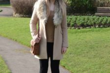 With light brown shirt, leggings, ankle boots and brown small bag