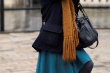 With navy blue mini coat, orange oversized scarf, skater skirt and black tights