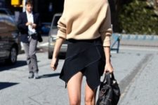 With oversized sweater and unique black skirt