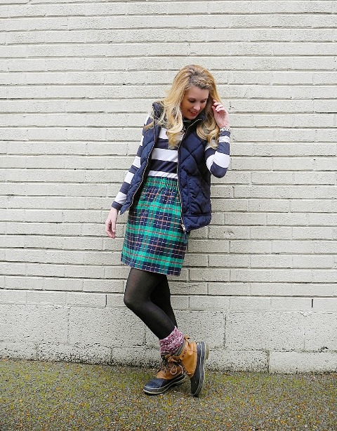With striped shirt, plaid skirt and puffer vest