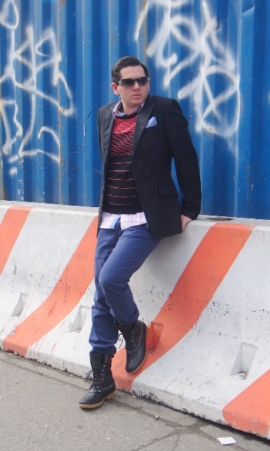 With striped sweater, blue trousers and black jacket