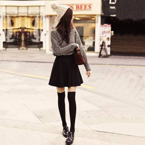 With sweater, mini skirt and beanie