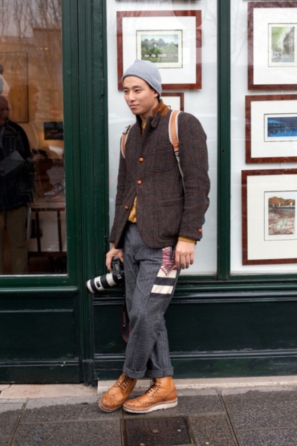 With tweed blazer, gray pants and beanie