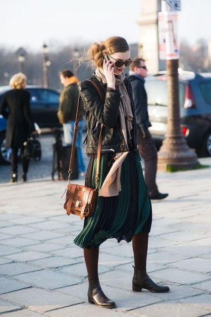 With two color pleated skirt, leather jacket, oversized scarf ad brown mini bag