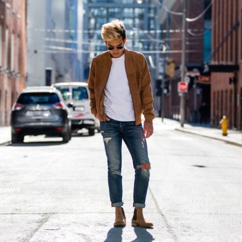 With white shirt, brown jacket and distressed jeans