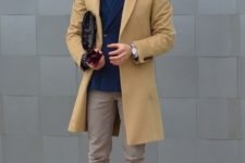 With white shirt, marsala tie, navy blue blazer, beige pants and boots