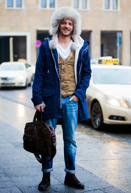 With white t shirt, suede vest, cuffed jeans and fur hat