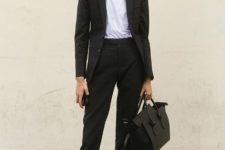 With white t-shirt, suit and black bag