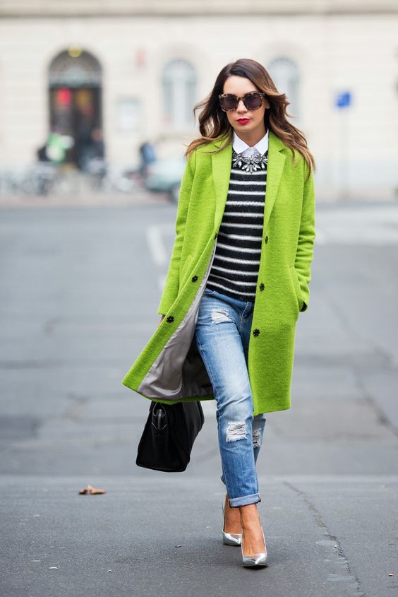 trendy greenery coat with heels, jeans and a striped sweater