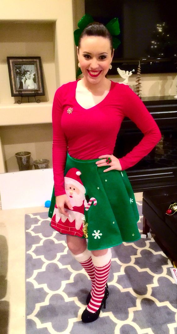 a green Santa tree skirt and a red sweater