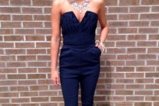 19 navy jumpsuit, black heels and a statement necklace