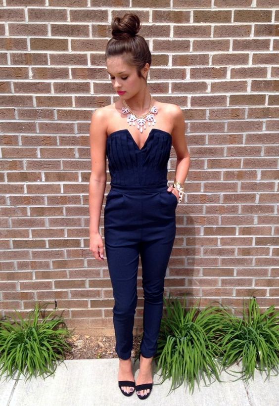 navy jumpsuit, black heels and a statement necklace