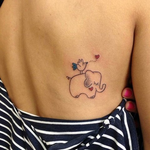 Baby elephant with bird on the back