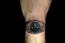 Black and emerald watch tattoo