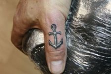 Black and white tattoo on the finger
