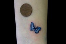 Blue small butterfly tattoo
