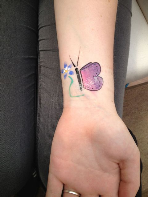 Butterfly with flower tattoo on the wrist